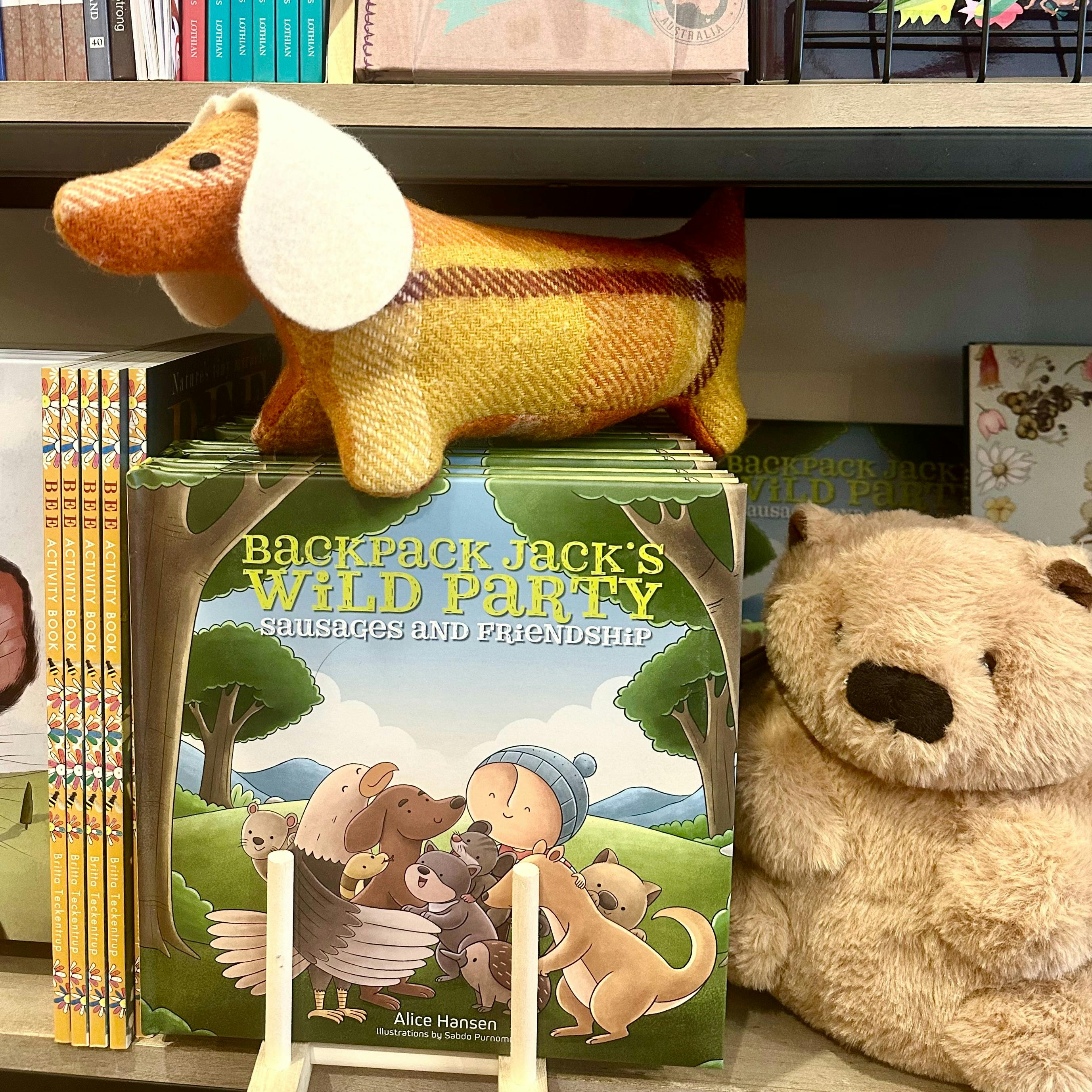 Tasmanian children's books and toys on a bookshelf
