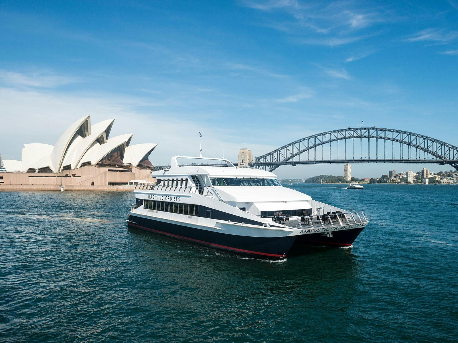 Magistic vessel on Sydney Harbour with opera house and harbour bridge in the background.