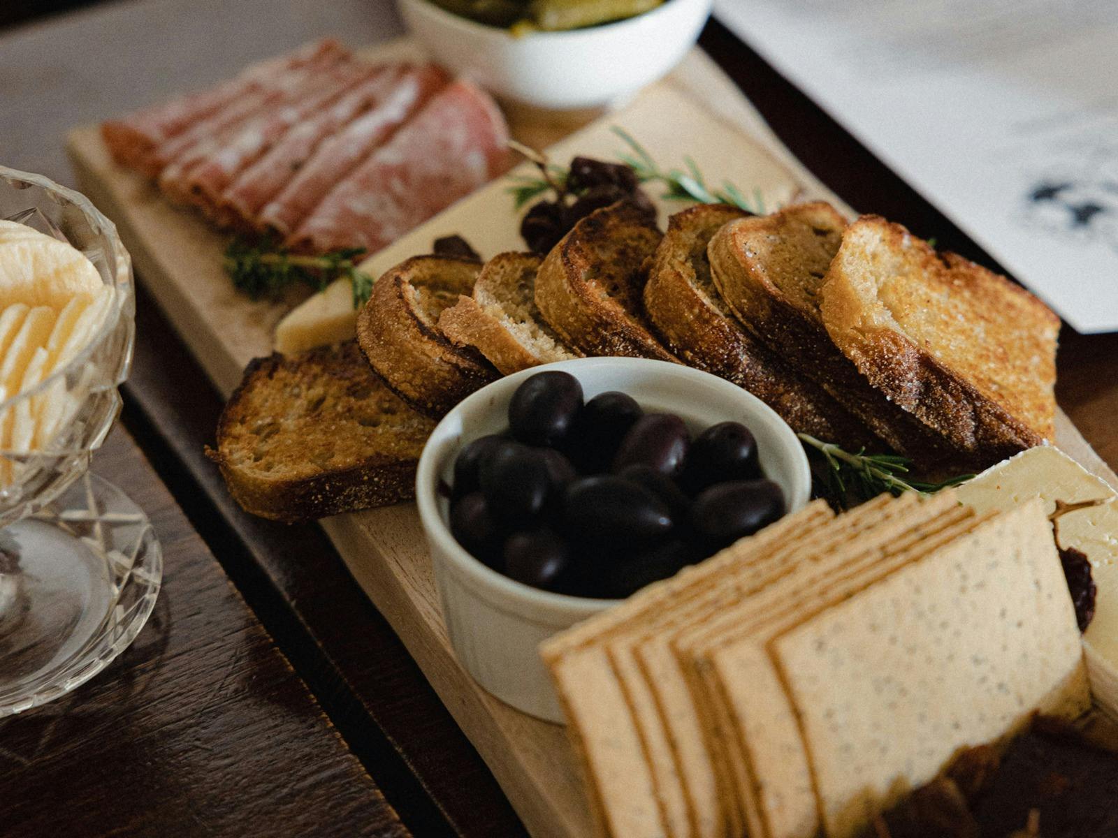 Bite to eat? Our Misto Platters come with cheese, charcuterie, local pickles, warm olives and bread.