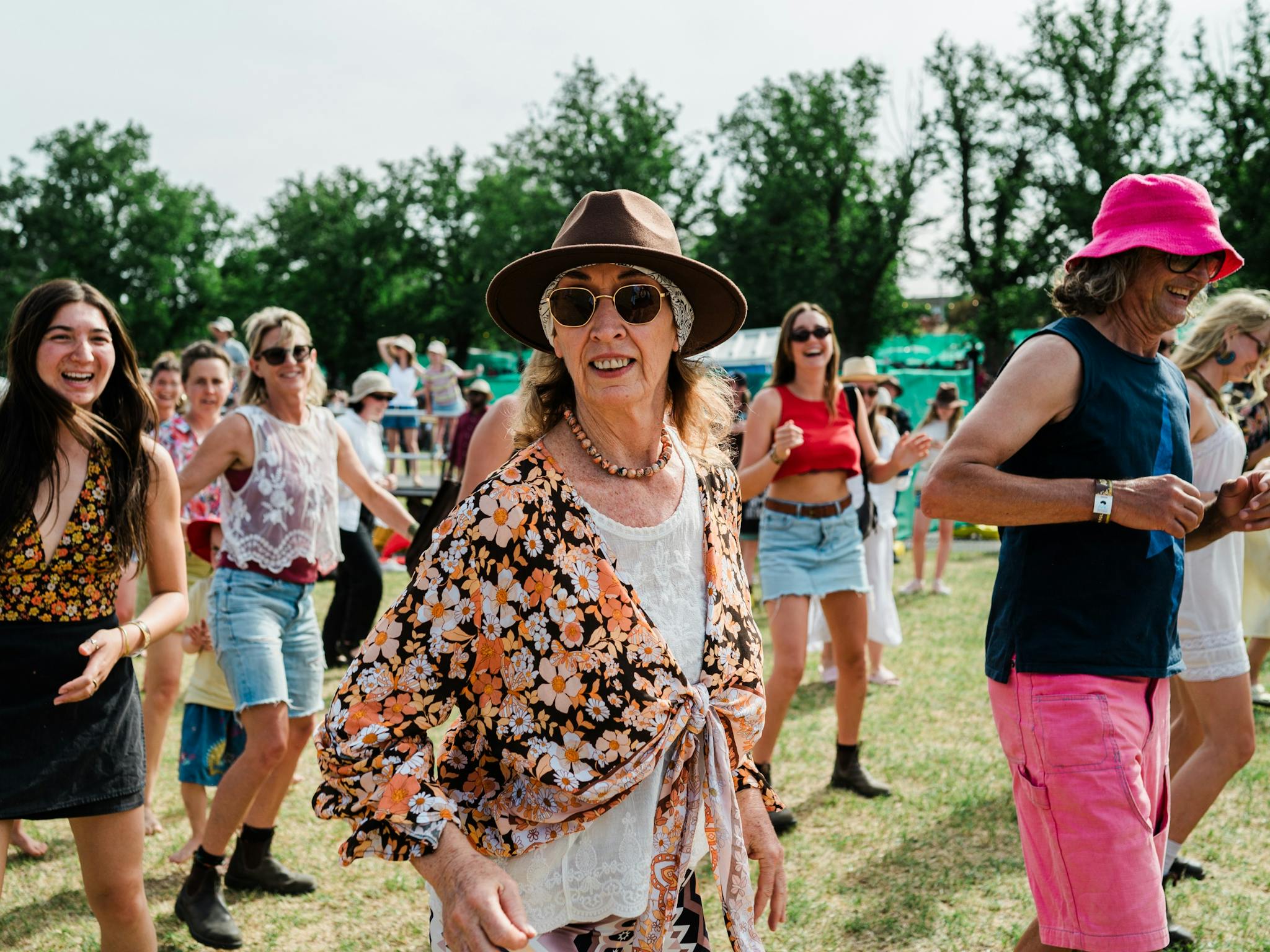 A woman smiles at the camera while dancing at the main stage.