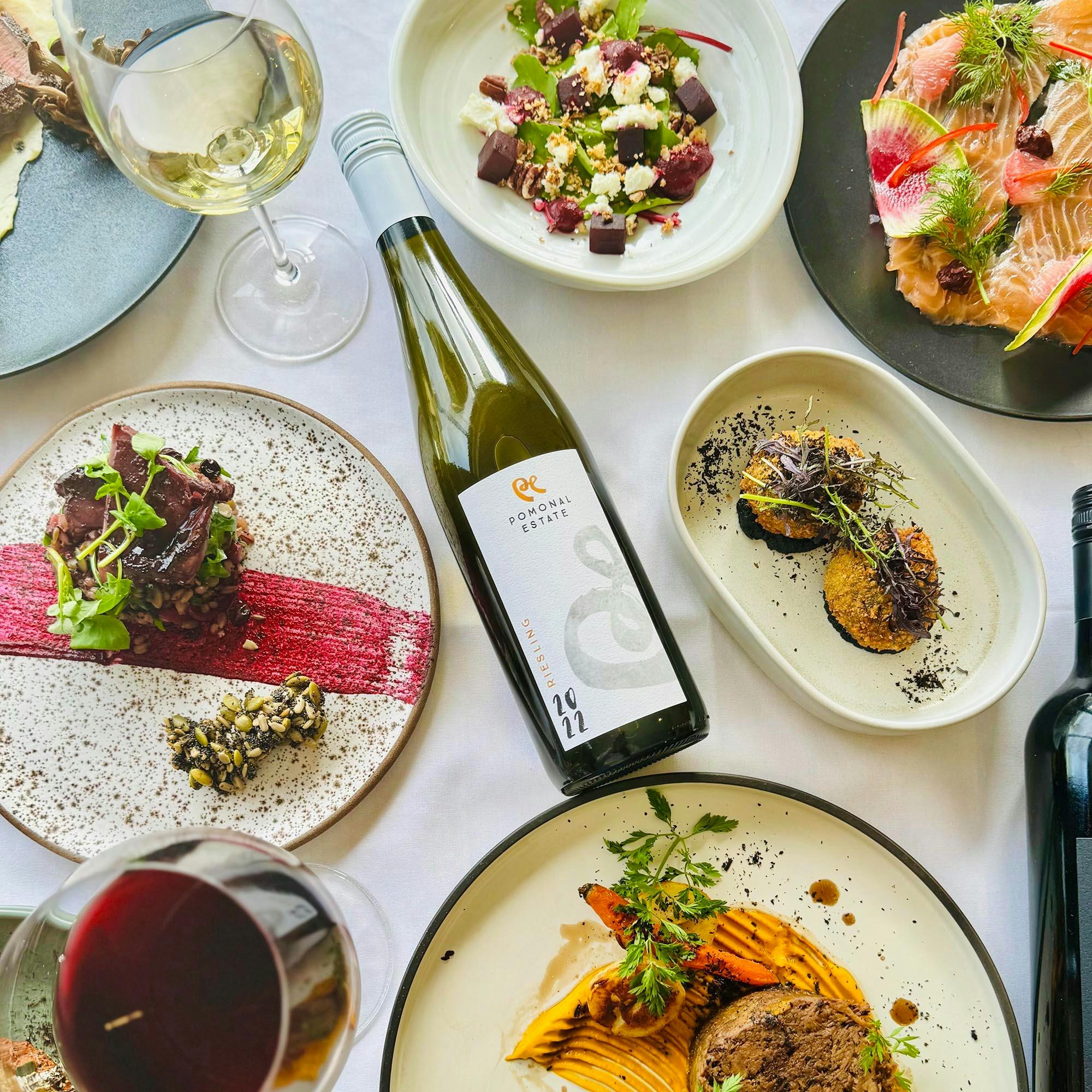 Pomonal Estate Riesling bottle surrounded by food prepared by Iris by Block and Cleaver