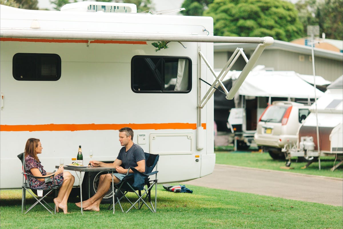 Couple drinking wine outside campervan
