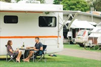 Couple drinking wine outside campervan