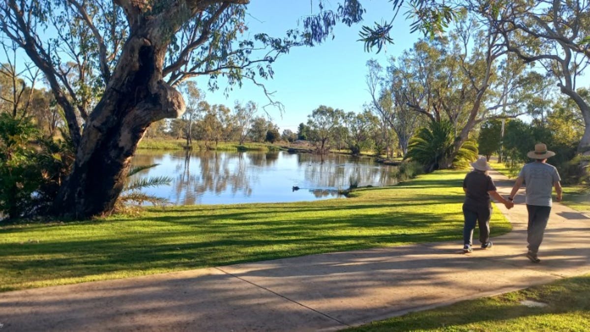 Couple walking along the footpath beside the Yelarbon Lagoon