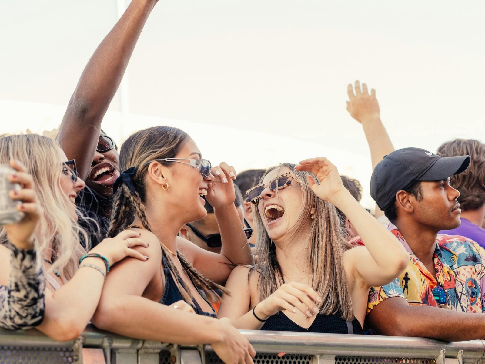 Two friends enjoying a concert in a crowd of people Two friends enjoying a concert in a crowd of people