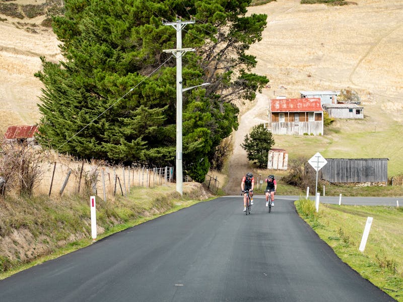 2 riders climbing up a hill