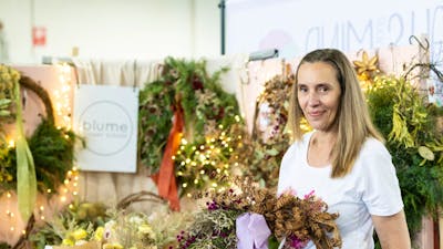 Blume Flower School holding a wreath