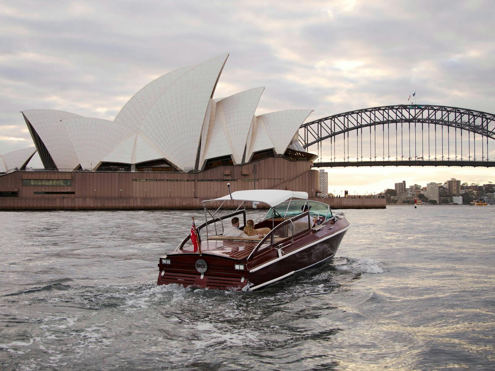 MV BEL private cruise on Sydney Harbour with Sydney city skyline and Harbour Bridge.
