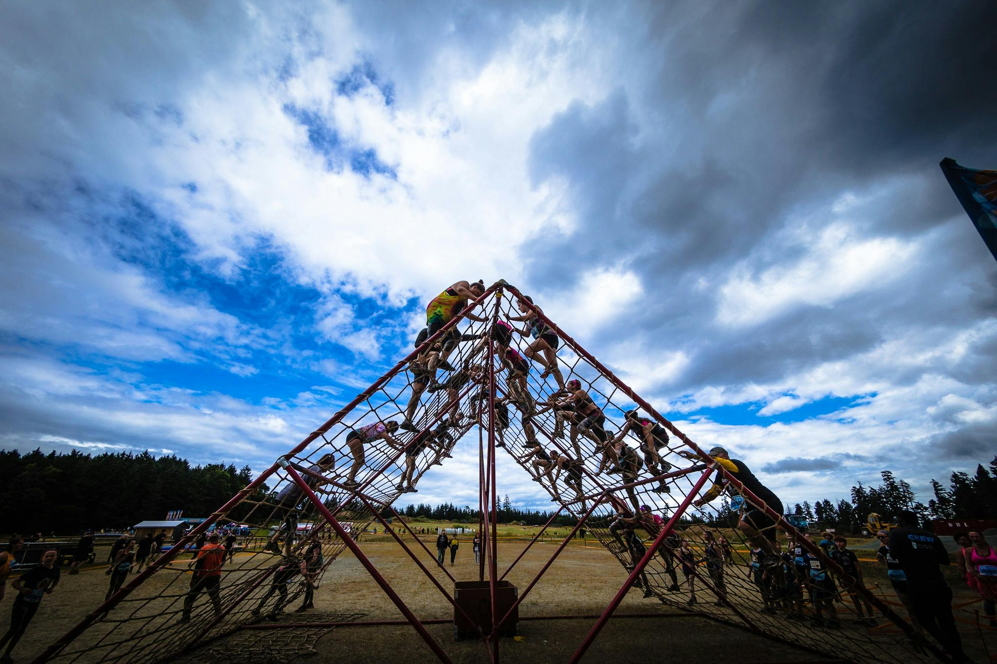 People climbing the cargo net obstacle