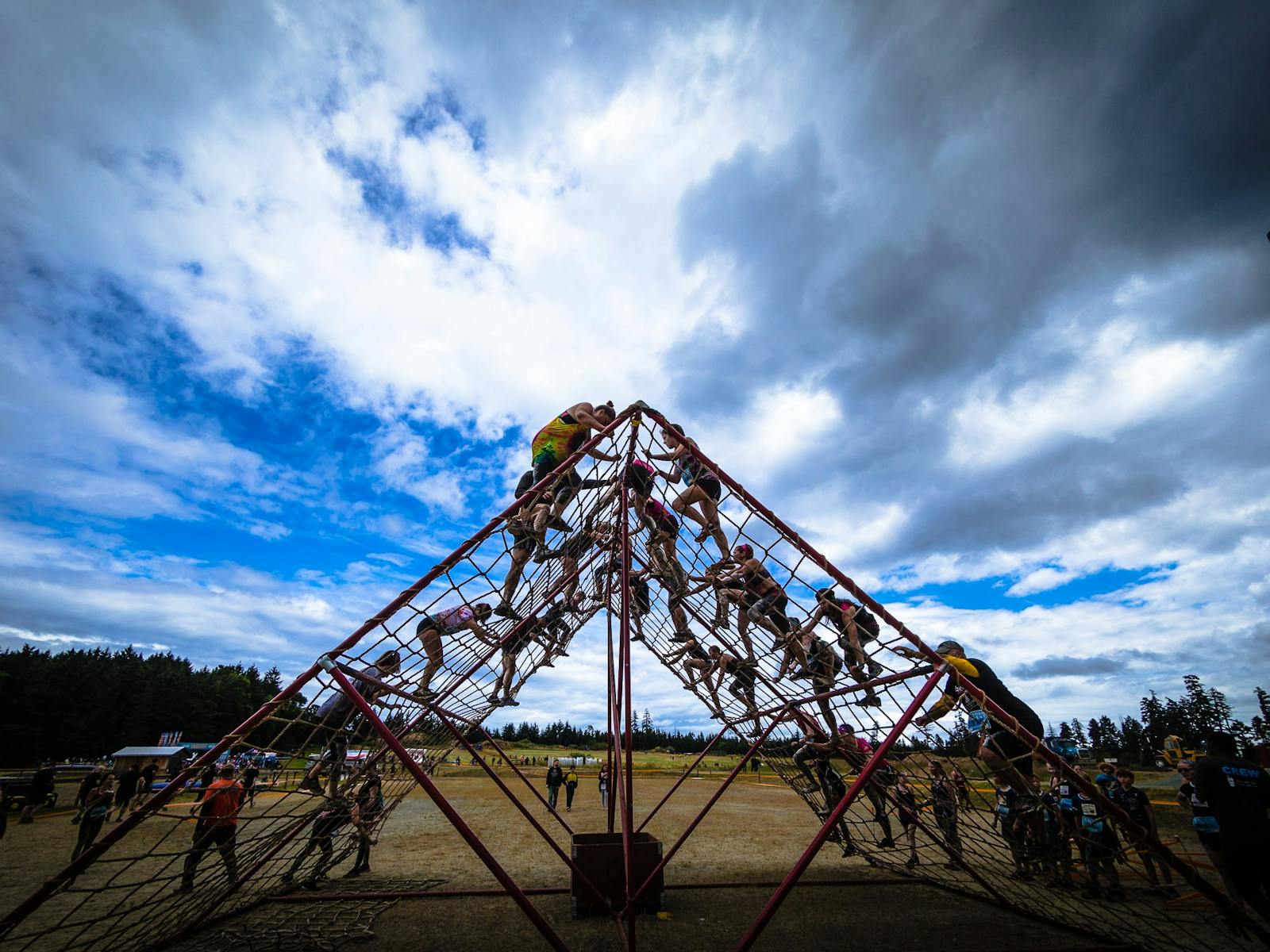 People climbing the cargo net obstacle