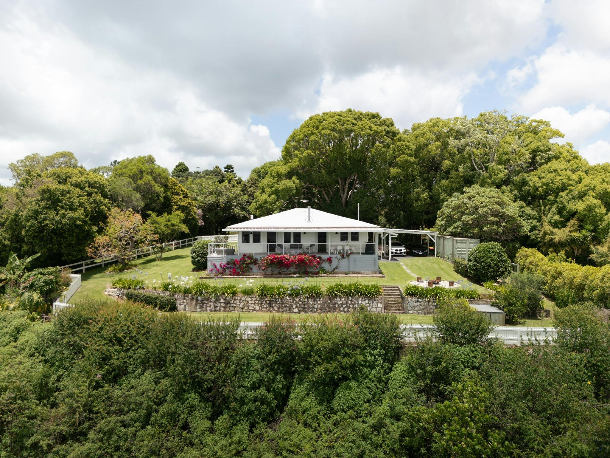 on a private escarpment, surrounded by green gardens and established heritage trees.