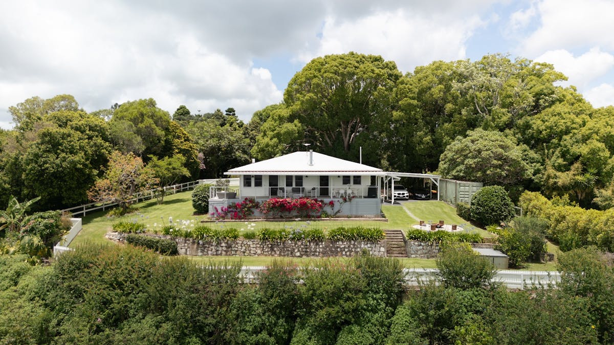 on a private escarpment, surrounded by green gardens and established heritage trees.