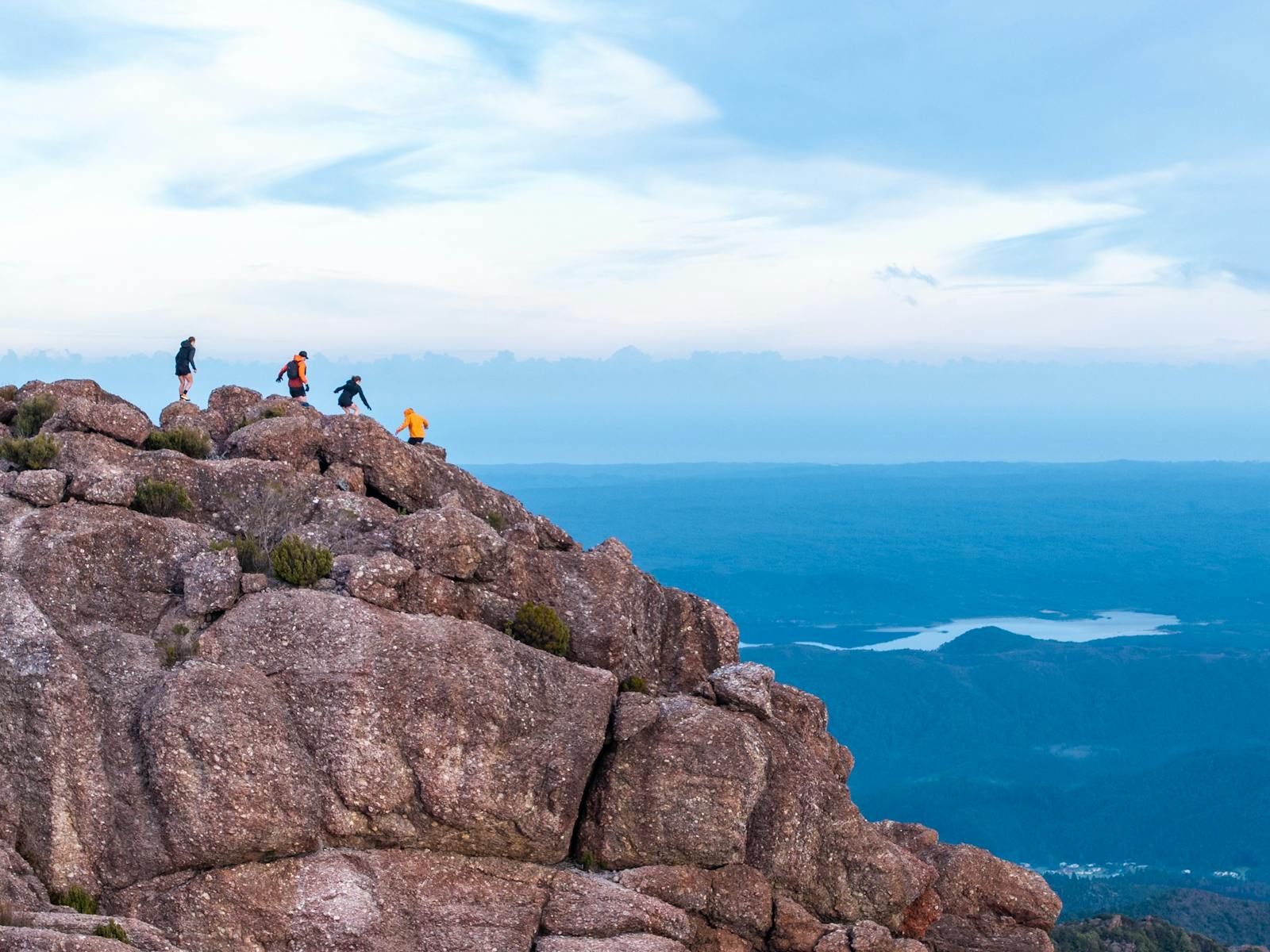 Four runners at the top of a ridgeline