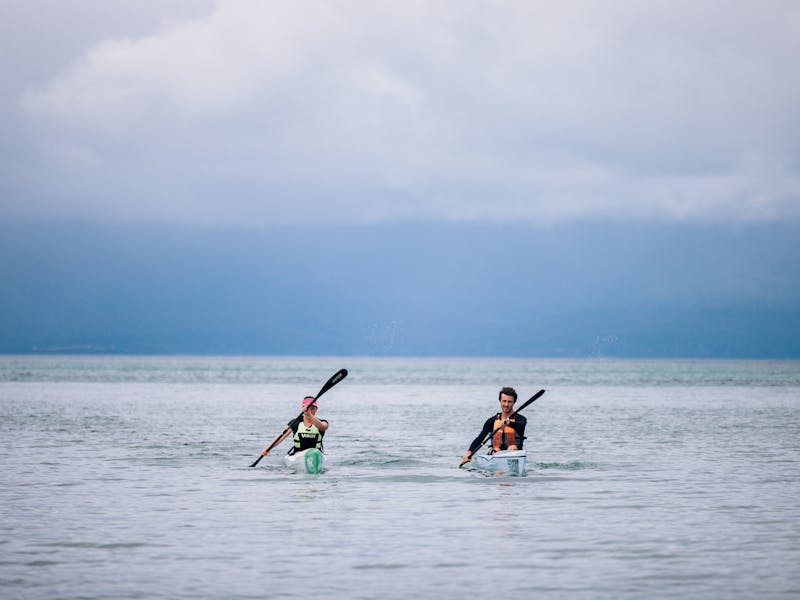 Two paddlers approaching the shore