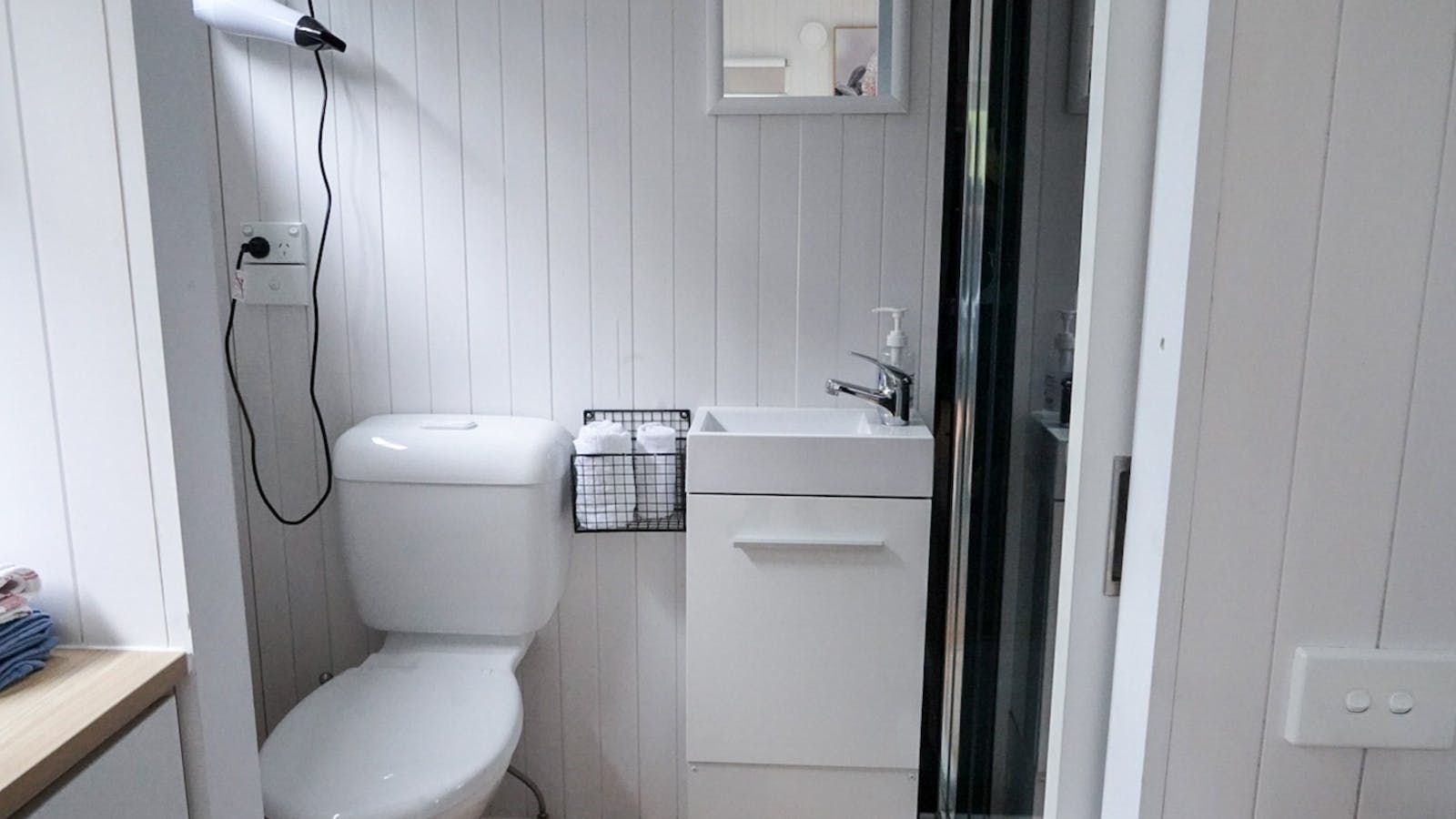 A comfortably-sized, sustainable bathroom with hot water system