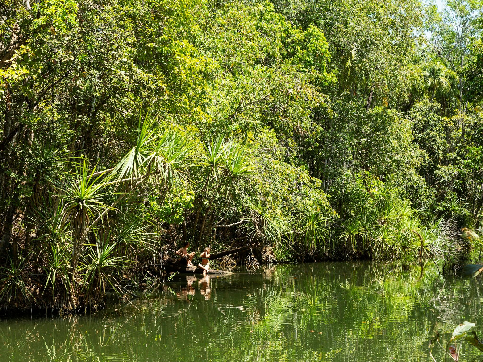 Couple sitting in the pool at Berry Springs