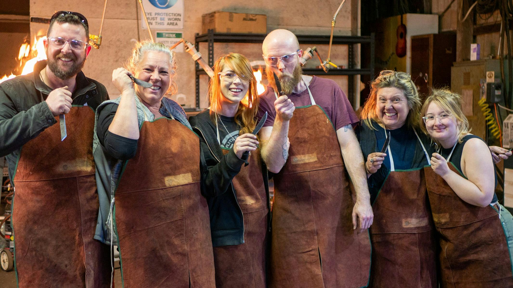 Group of people blacksmithing