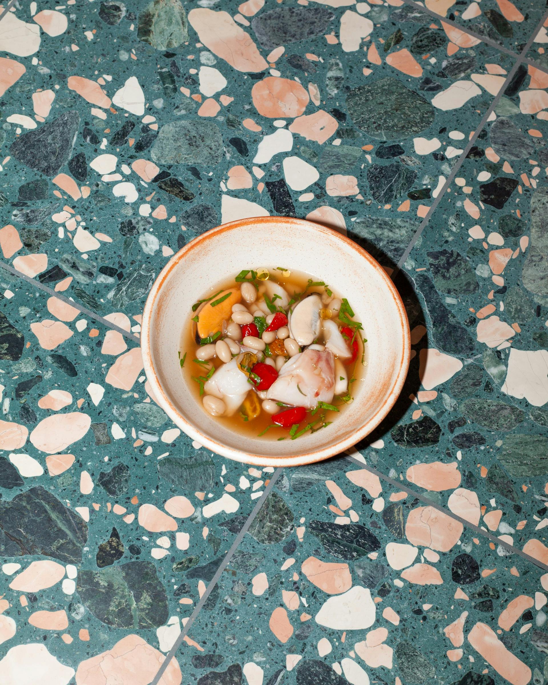 blue eye in broth with sun dried tomatoes and beans