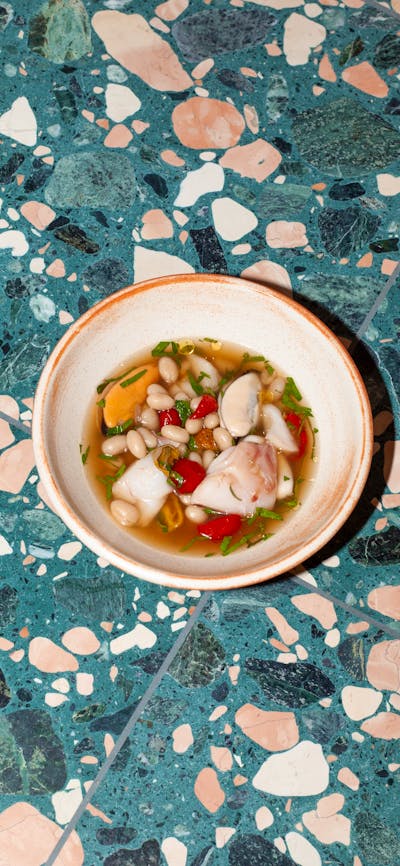 blue eye in broth with sun dried tomatoes and beans