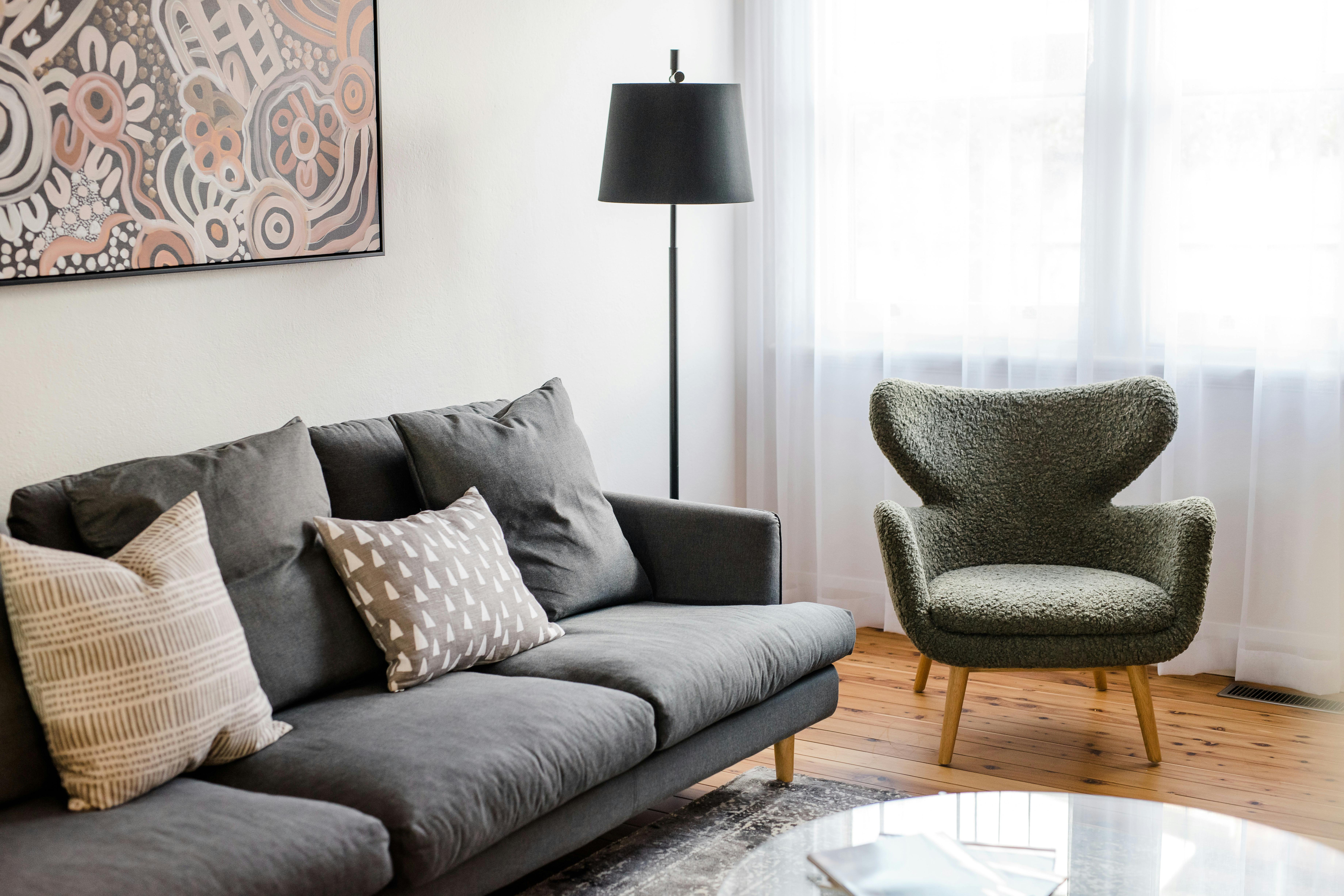 Cosy sofa and chair in old style character filled lounge room