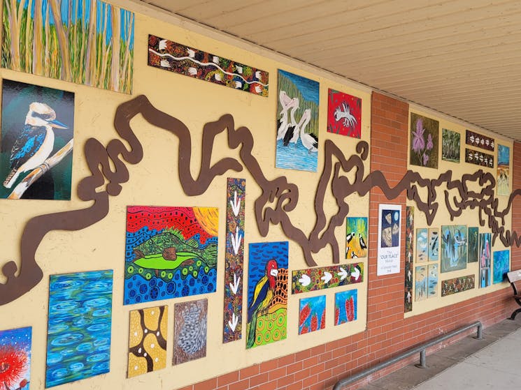 windy metal recreation of the murray river along a wall with individual art work from local students