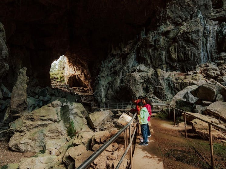 Visitors explore Victoria Arch, the largest chamber of Fig Tree Cave. Credit: Remy Brand/DPE &copy;