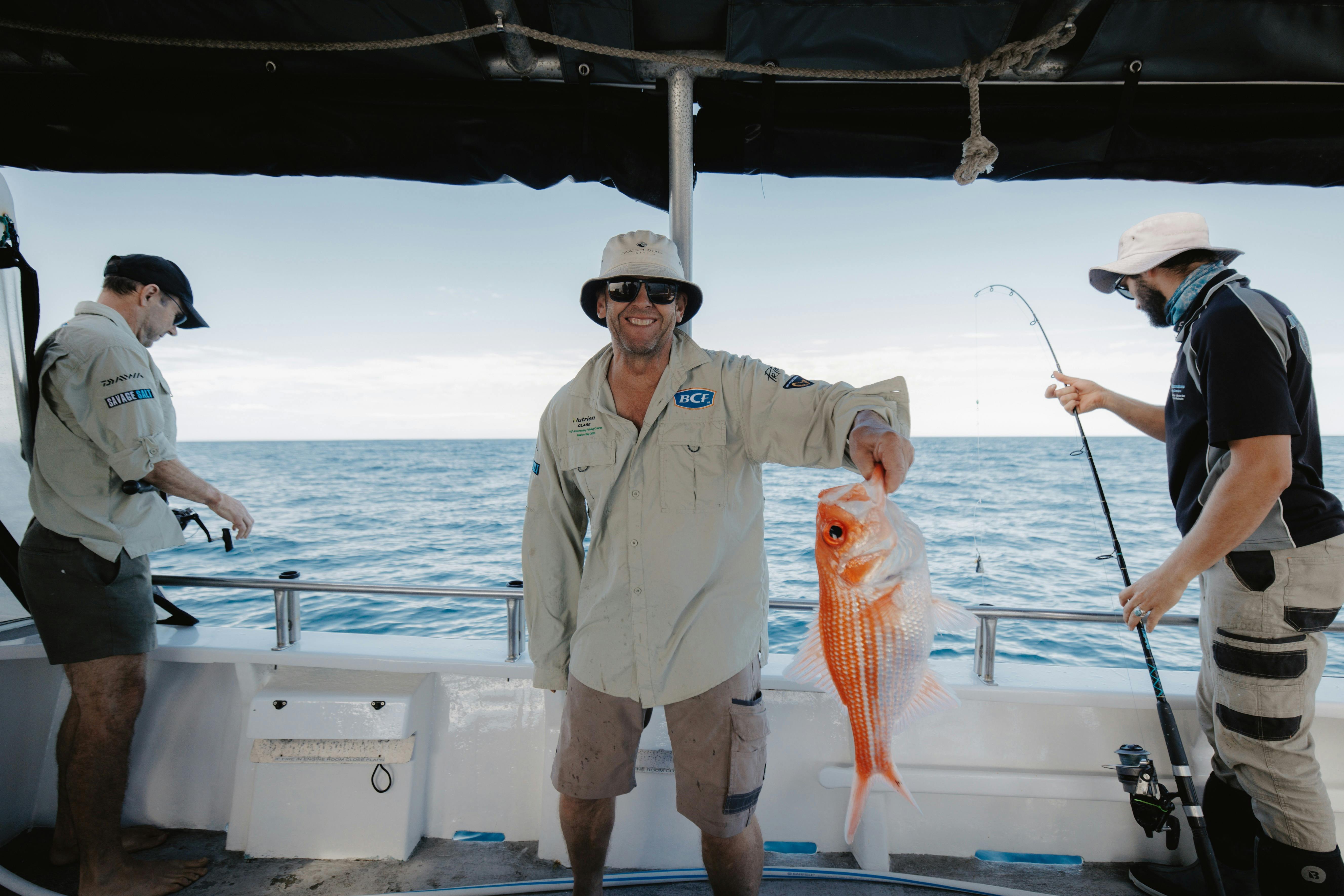 Reef Encounters Fishing Charters' client with his catch - a large Nannygai
