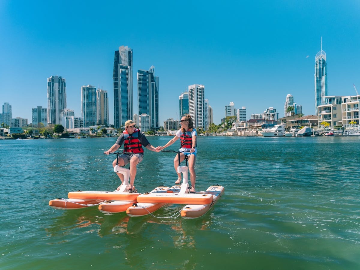 Couple holding hands on waterbike on the water