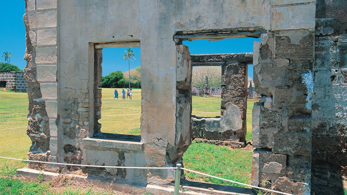 Tour group walking around ruins.