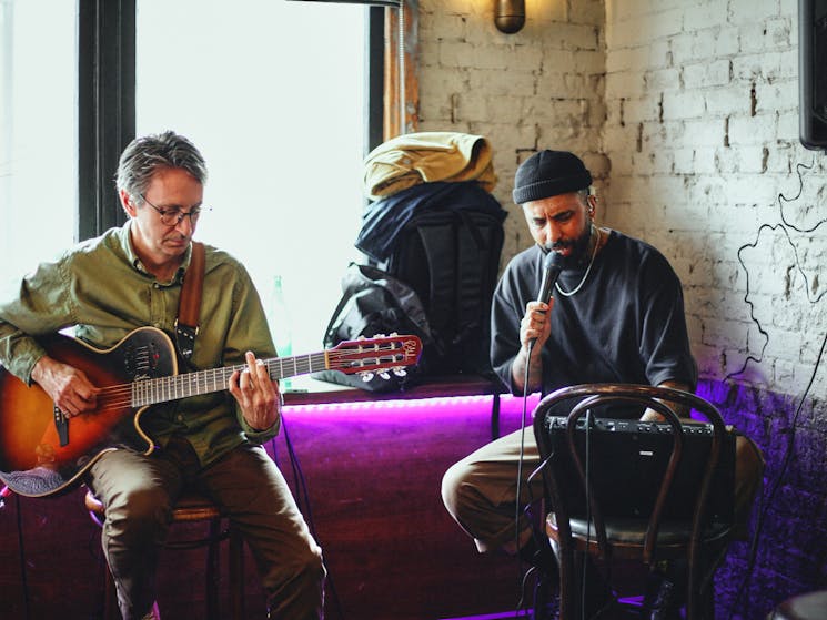 Two live music artists with guitar and microphone