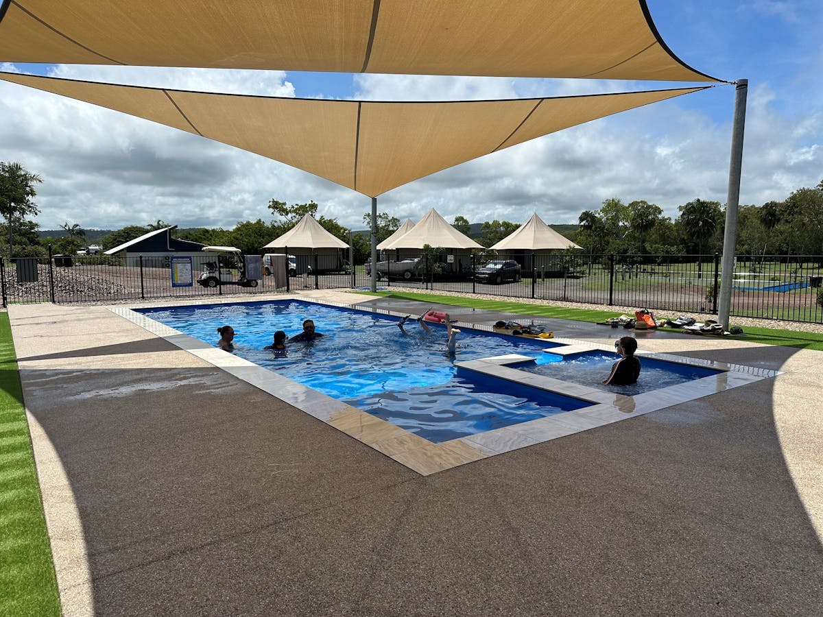 People swimming in pool and in spa