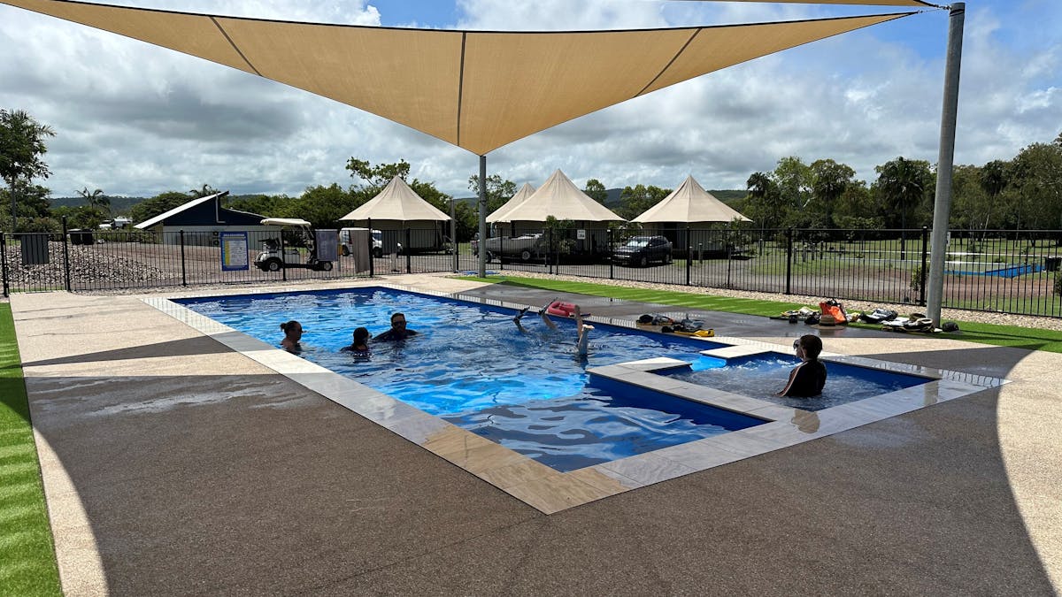 People swimming in pool and in spa