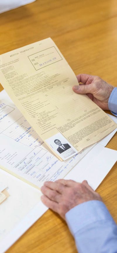 Photpgraph of a visitor reading archival records at a table
