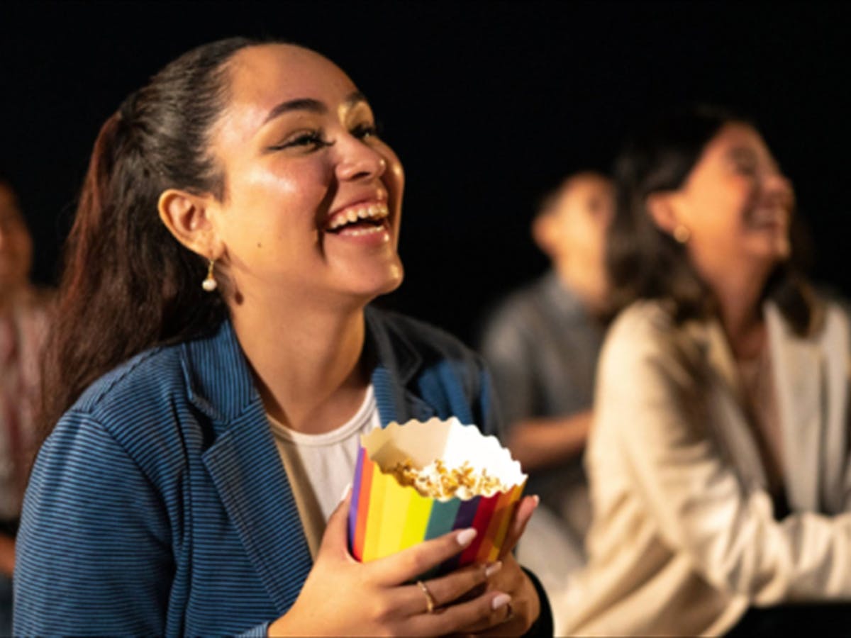 Girls holding popcorn smiling