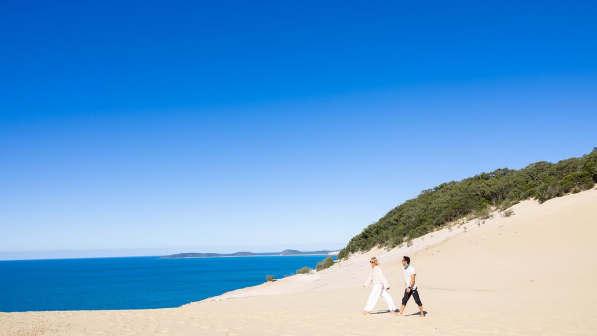 People walking on the sand at Carlo Sandblow