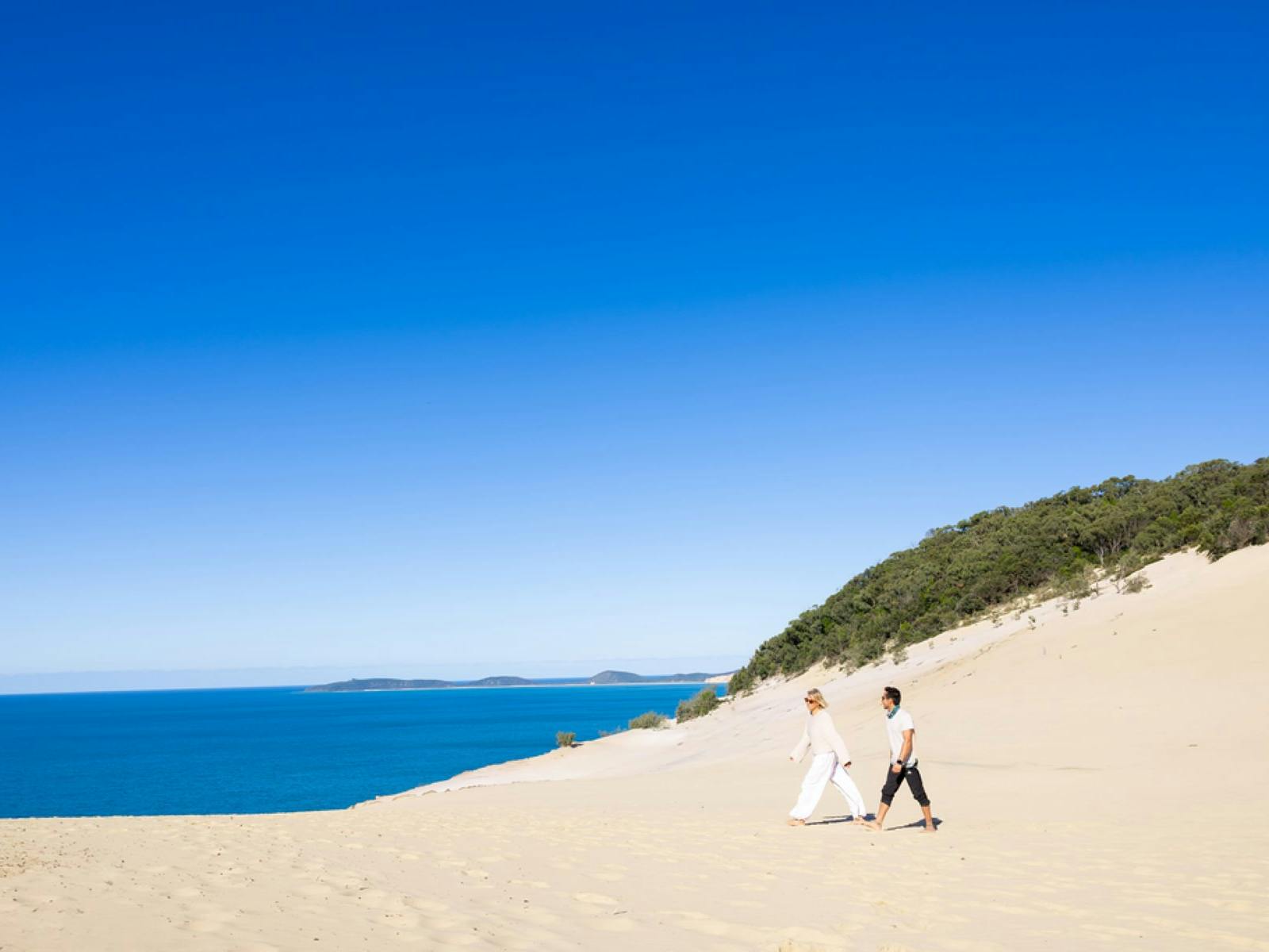 People walking on the sand at Carlo Sandblow