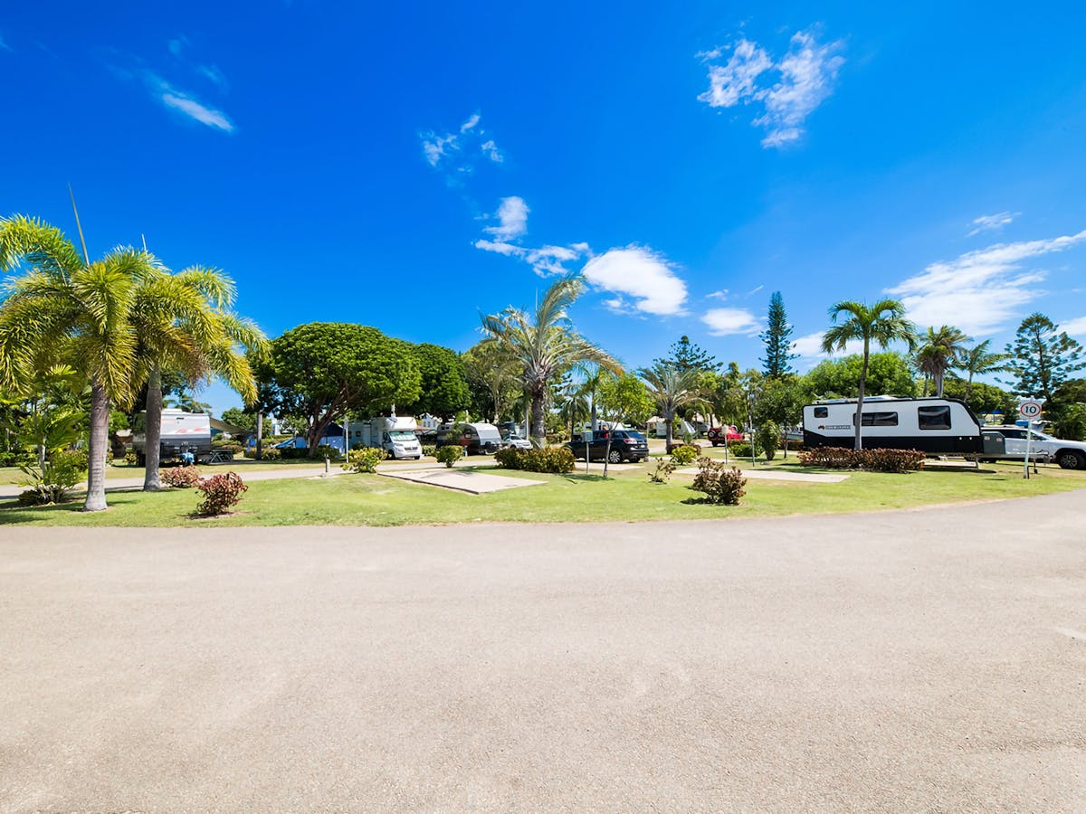 Scenic view of the holiday park with open green spaces and trees.