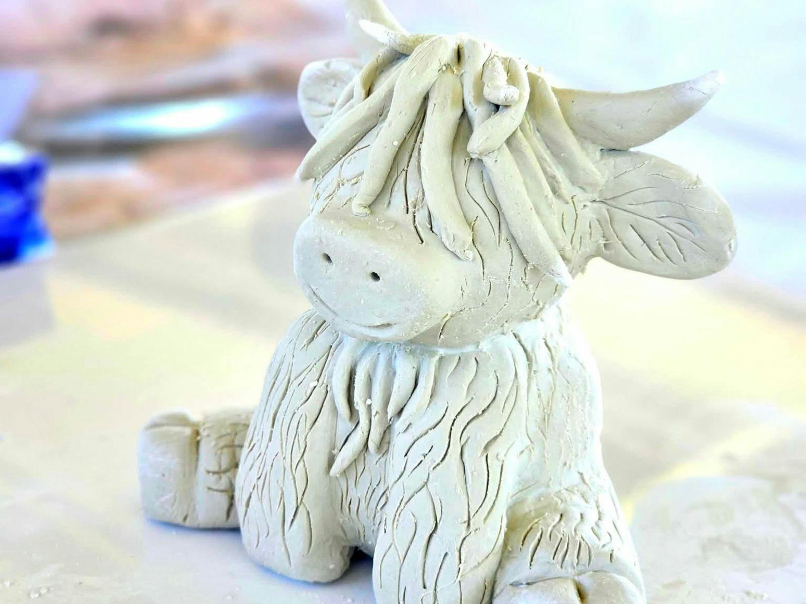 Sitting Clay Highland Cow