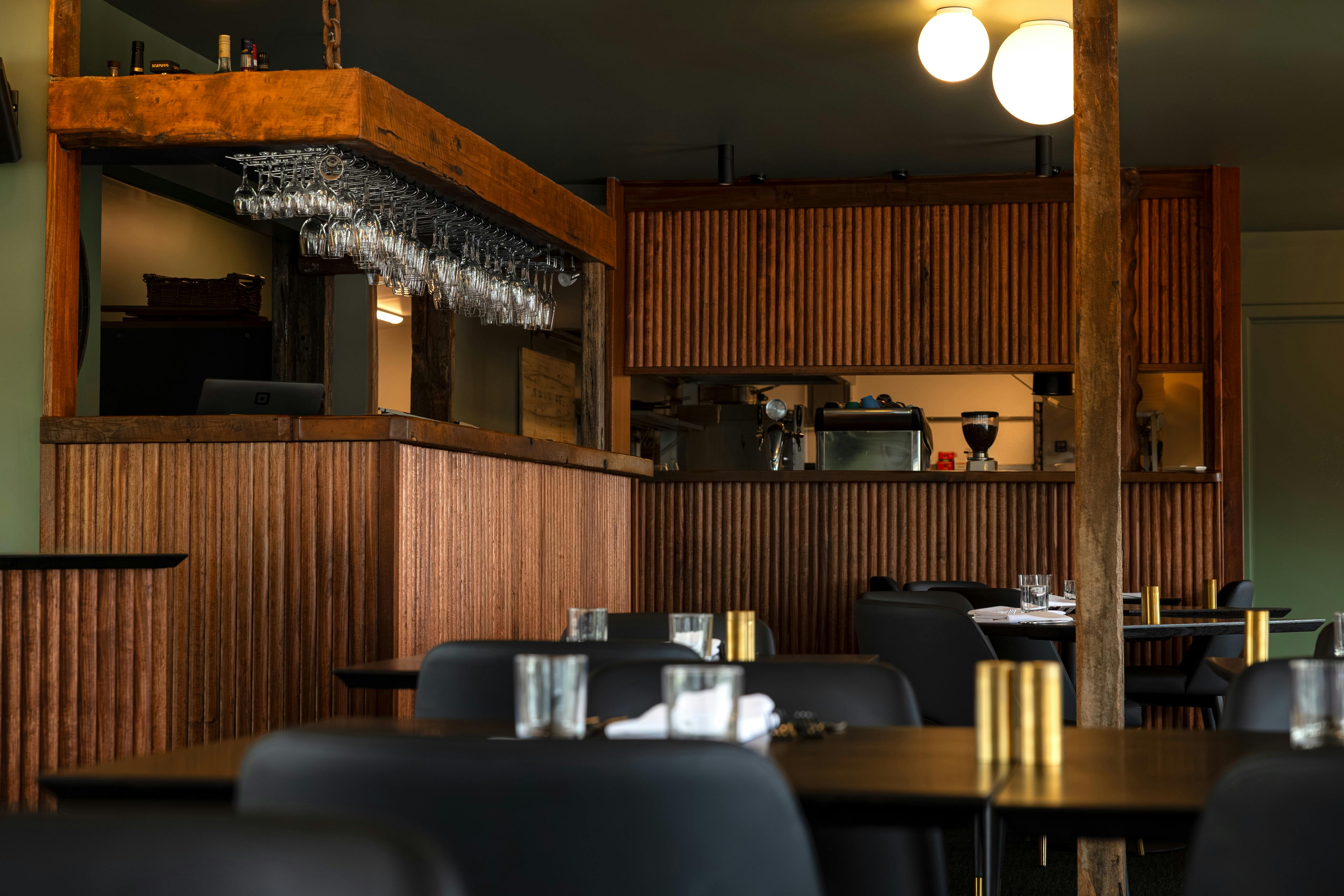 Restaurant tables and bar behind