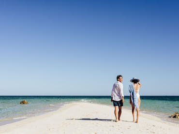 Couple enjoying a secluded sand cay off Lizard Island Couple enjoying a secluded sand cay off Lizard Island