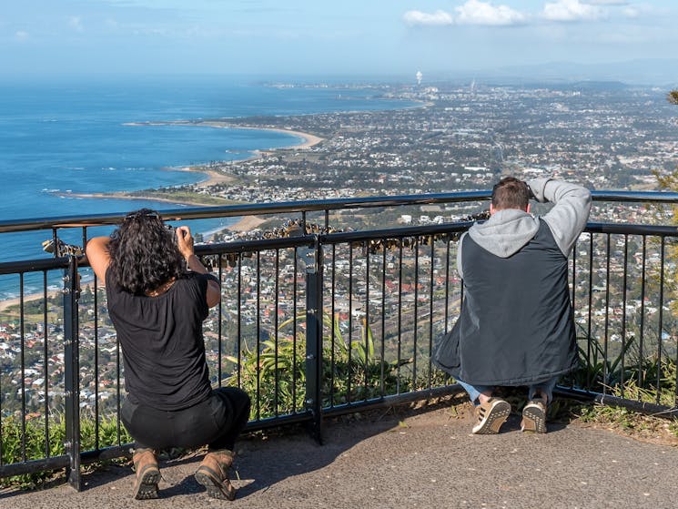 people taking photos from a lookout over the south coast