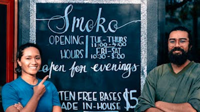 Owner and sister (Kavita) with outdoor hand painted signage