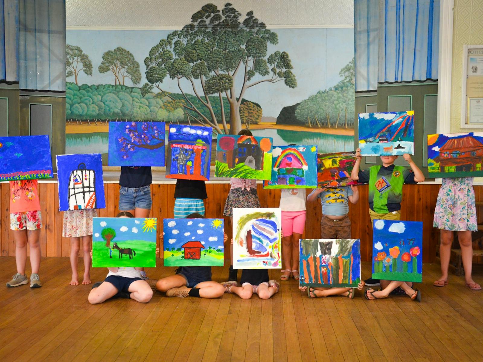 Students displaying their paintings