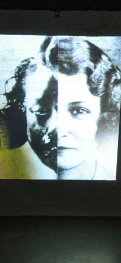 Black and white image of girl projected on a wall