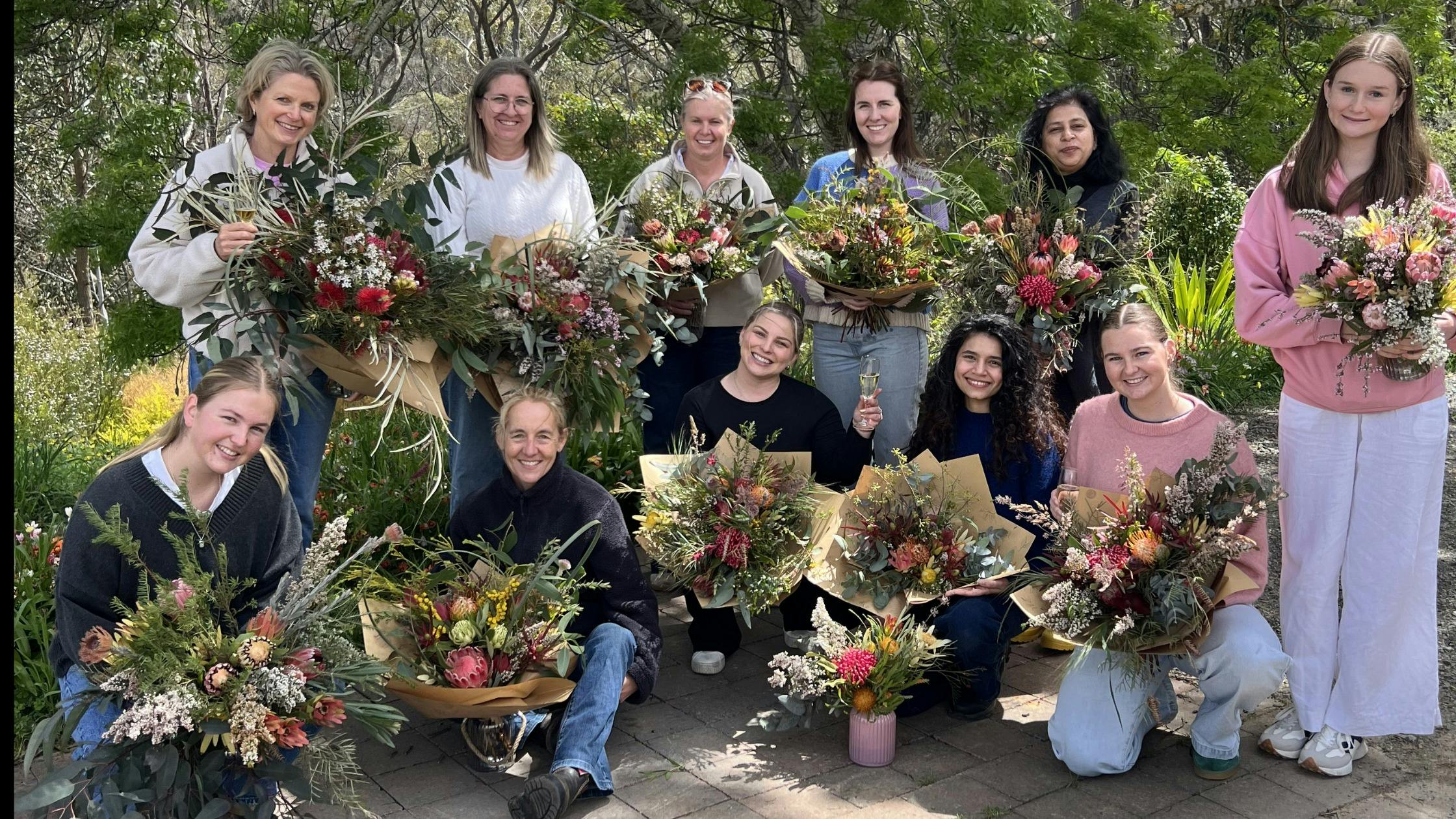 Workshop participants showcasing their unique bouquet creations