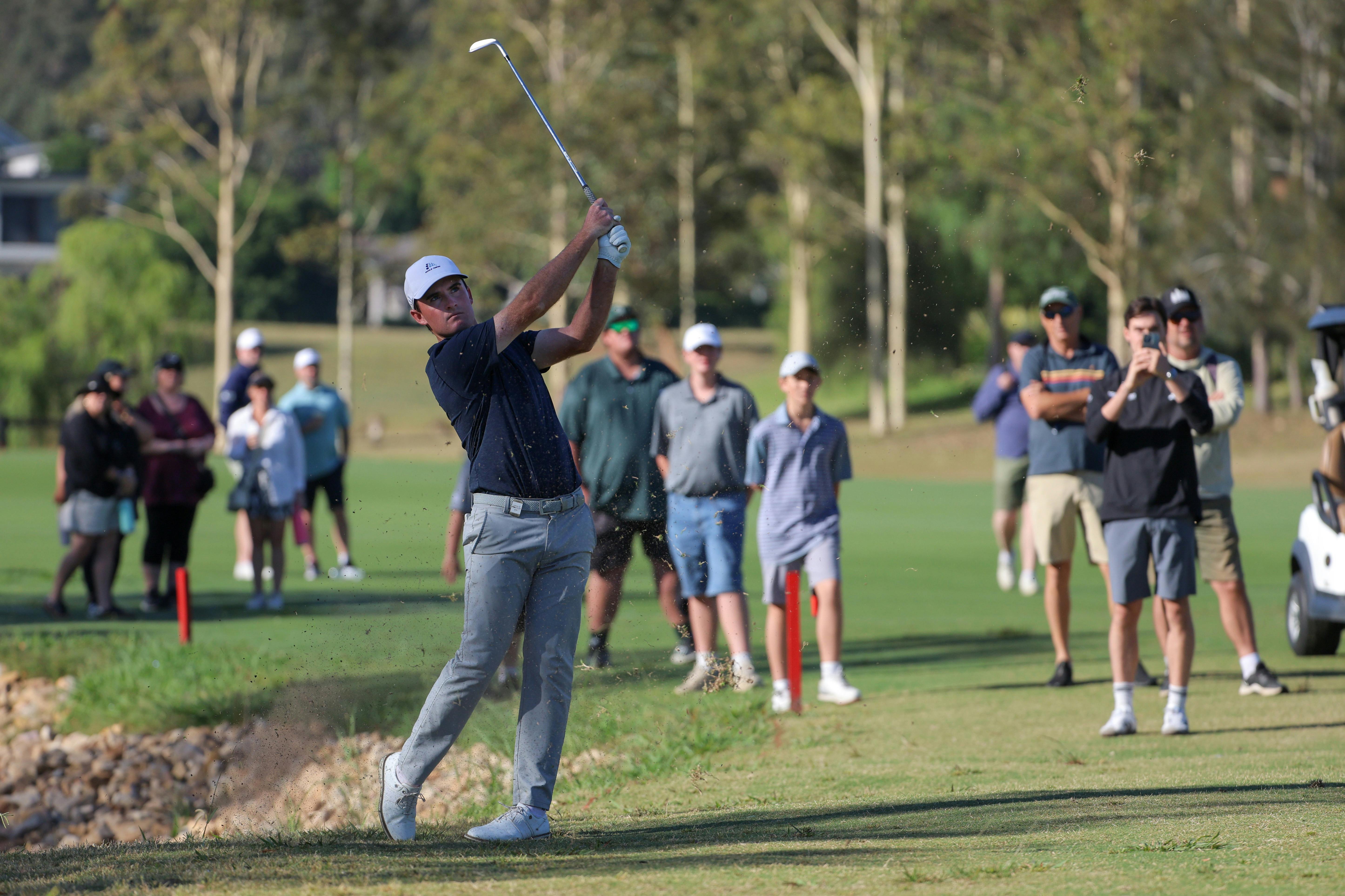 Golfer on the fairway with spectators