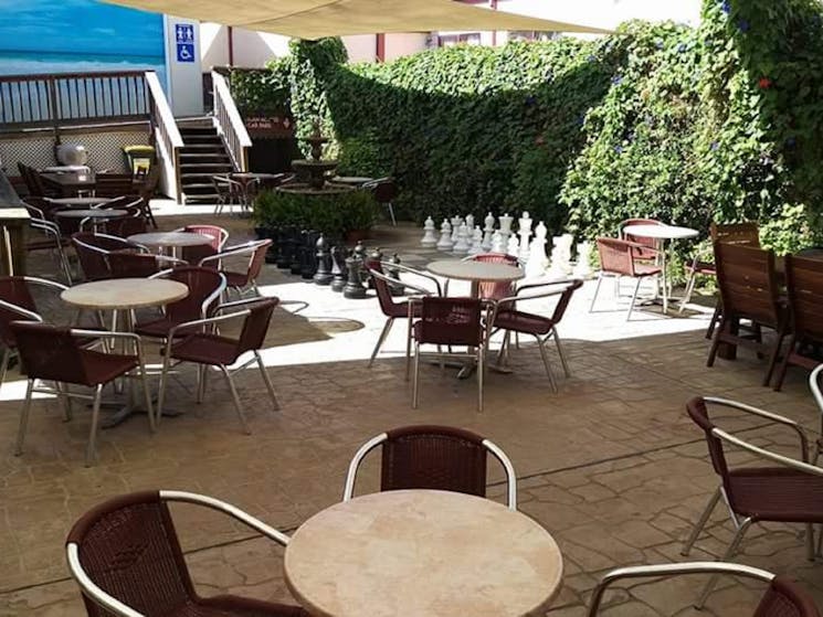 Relax inside or enjoy the fresh air in the covered courtyard. Play chess on the giant outdoor board