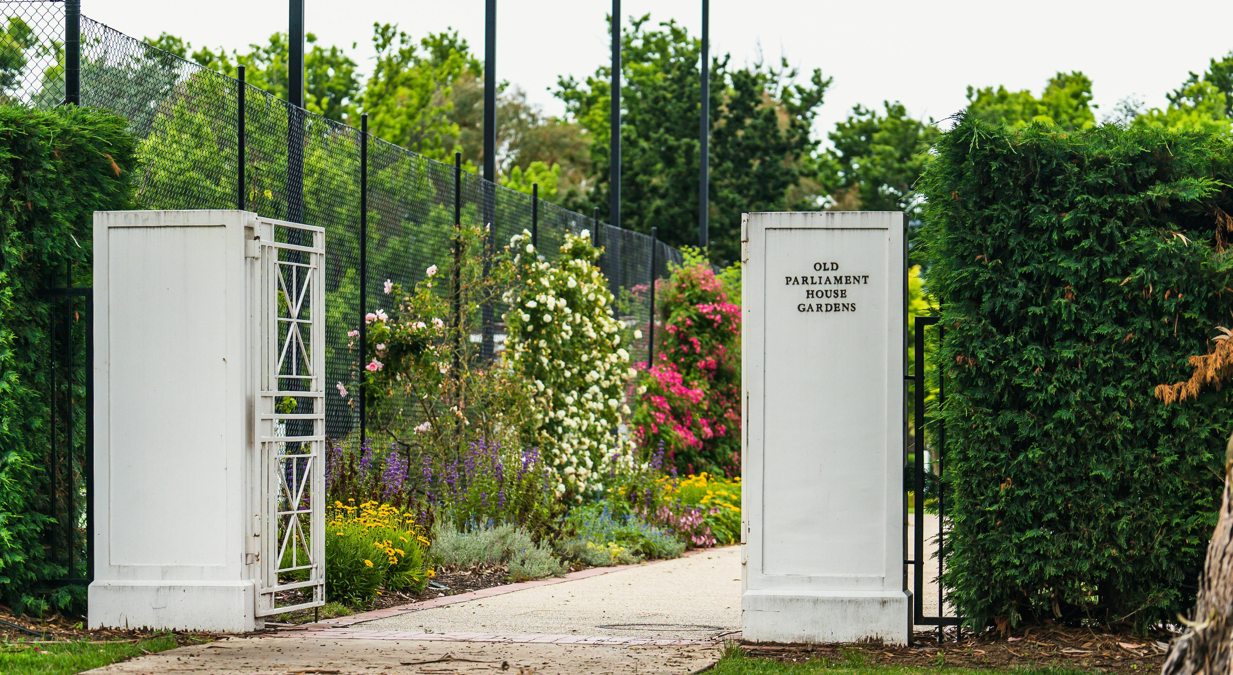 An outdoor area with the words "Old Parliament House Gardens"