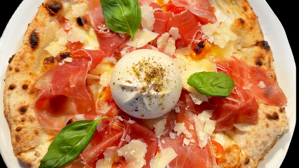 Cozy Italian restaurant with wood-fired pizzas and warm, inviting atmosphere.