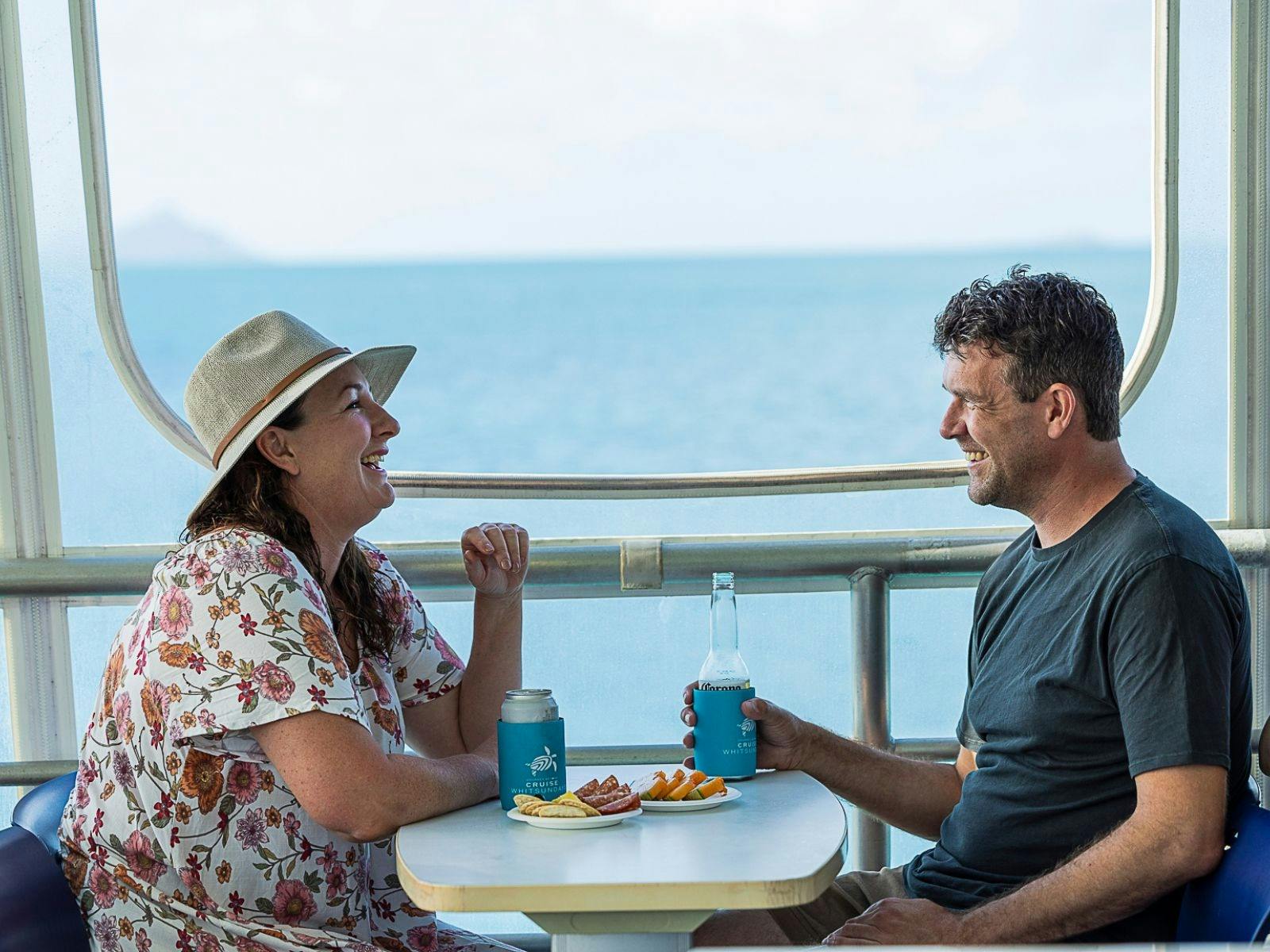 A couple laughing enjoying afternoon tea